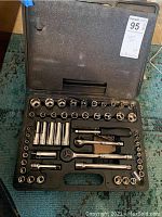 Full view of open plastic carrying case with all sockets and tools organized.