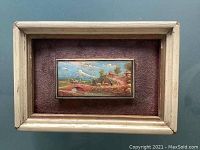 Front view of one miniature oil painting in a light wooden frame with an Andean landscape showing campesinos crossing a stone bridge with llamas.