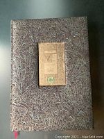 Front cover of the hardcover book showing the decorative marbled design and central label.