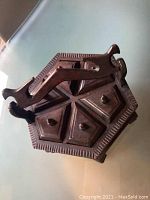 Top view of the hexagonal wooden spice container closed, showing handle and lid design