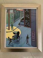 Framed art print featuring a Tintin scene with a rickshaw and street signs in Asian characters.