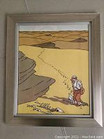 Framed color print of Tintin and Snowy in desert with animal bones.
