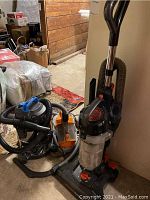 Three vacuum cleaners together showing general size, condition, and included parts