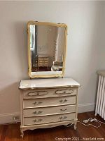 Full view of French Provincial style dresser with mirror above it, showing the dresser's design, drawers, and top surface.