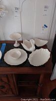 Overview of the set including the swan dish, leaf dish, shell dishes, scalloped plate and pedestal compote.
