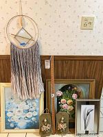 Overview of all wall art and decor items including framed paintings, porcelain wall hangings, and macrame hanging