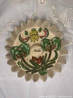 Full front view of circular Cuban hay wall decor showing coconut trees, bananas, and a watermelon slice accented with painted and sculpted details.