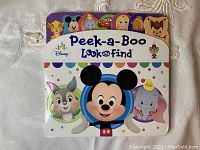 Front cover of Disney Peek-a-Boo Look and Find book showing characters and title with a peek-a-boo hole.