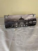 Handbag with black and white photographic design showing Bellas Artes museum dome and cityscape, with metal grommets and silver chain strap