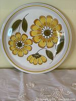 Top front view of the Mikasa yellow flower design plate showing full floral pattern and condition.