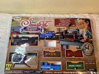 View of the full unopened box showing the contents and Santa Fe Special branding with some damage to box.