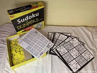 Sudoku For Dummies game open with yellow tiles, instruction sheet, and four puzzle boards displayed
