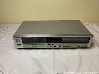 Front view of the Technics stereo cassette deck showing power switch, cassette compartment with window, control buttons, and tape counter.