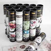 Multiple cylindrical containers of decorative transfer decals with floral, botanical, and vintage designs shown as part of Mango Reclaimed finishing products.