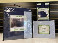 Photo of the Queen size bedding set components including Grover Essentials reversible quilt set, Royal Bamboo sheet set, and Royal Bamboo duvet cover in their packaging, navy color combo.