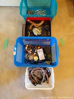 Overhead view of four baskets filled with bracelets, necklaces and chokers.
