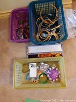 Overview of three baskets containing assorted jewelry