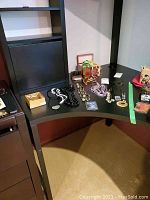 Overall view of necklaces, pendants, jewelry boxes and LED clip displayed on black desk