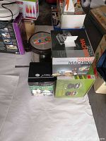 Photo of the lot showing pasta machine box, thermal heat pot box, rice cooker box, and other kitchen appliances on shelf