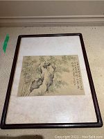 Full view of framed watercolor painting showing bamboo scene, rock stump and calligraphy