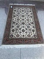 Full top view of rug laid flat outdoors, showing overall pattern and border