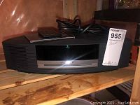 Front view of Bose Wave Music System unit showing CD slot, digital display, front speaker grilles