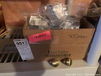 Box containing approximately 45 individually packaged Lee Valley metal cabinet knobs in plastic bags, labeled as new.
