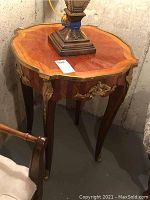 Front and side view showing overall design, wood veneer top, and metal detailing on legs and apron.