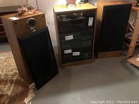 Pair of Technics SB-A15 speakers shown with one grill removed and one installed to display the drivers and cabinet condition.