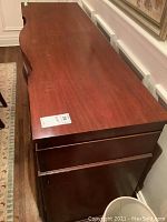 Top view of the light mahogany Sheraton style sideboard showing wood surface and top drawers