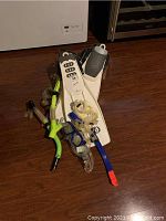 Photo of all snorkeling items piled together on wooden floor showing both flippers, snorkels and goggles