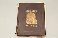 Front cover of the book showing embossed gold title 'Hogarth's Works' with visible wear on spine and edges.