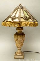 Full view of the working alabaster lamp with stained glass shade, showing overall design and condition.