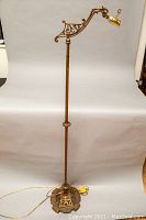 Full view of the 1930s Art Deco brass bridge arm floor lamp, showing the entire lamp including base, stem, and bridge arm with lamp socket.
