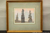 Framed pastel artwork showing three statues on stone pedestals with Prague cityscape in background under a pale sunset sky, measuring 12.5 x 14 inches, in gold frame with green mat.