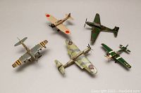 Top-down view of all five WWII model planes showing variety of colors and national markings