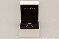 Pandora ring displayed in original branded box with lid open showing the ring inside.