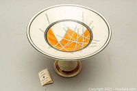 Front view of the Keith Campbell porcelain pedestal bowl showing the interior design and label.