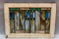 Front view of full stained glass panel and frame under neutral lighting