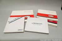 Five boxes containing placemats from Pimpernel and Jason brands displayed with closed boxes showing brand logos.