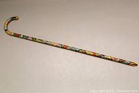 Full length view of the vintage cloisonné walking cane showing overall design and curved handle.