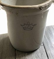 Front side view of the white ceramic crock showing the crown logo with number 2 in blue.