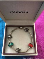 Pandora bracelet with charms inside branded box