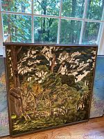 Framed swamp scene canvas art displayed near window, showing the full front view of the artwork and the frame.