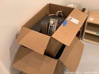 Wide shot of box containing Onkyo stereo components and speakers