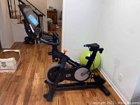 Full side view of NordicTrack S22i studio cycle with touchscreen and pedals