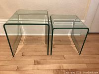 Both tables side by side on wood floor against wall