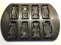 Full view photo of the Wilton Halloween cookie baking mold showing 8 detailed scary creature cavities including Frankenstein, Dracula, Werewolf and Mummy.