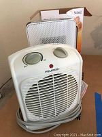 White Pelonis personal heater with controls and power indicator light, front and top view