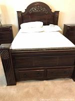 Front view showing full headboard, footboard and base drawers.